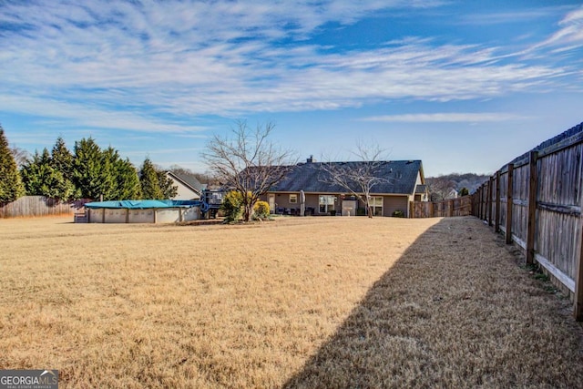 view of yard with a fenced in pool and a fenced backyard