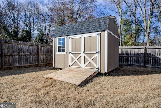 view of shed with a fenced backyard