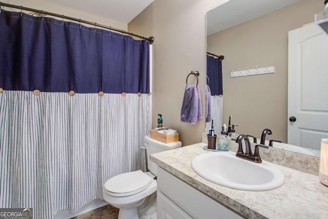 bathroom featuring vanity and toilet