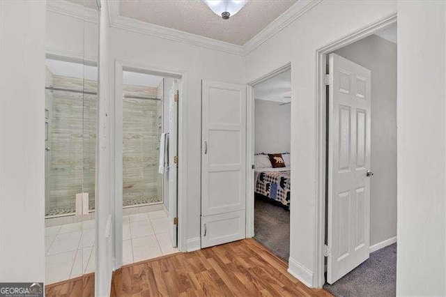 corridor with wood-type flooring and a textured ceiling