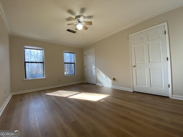 unfurnished bedroom with ceiling fan, crown molding, and dark hardwood / wood-style floors