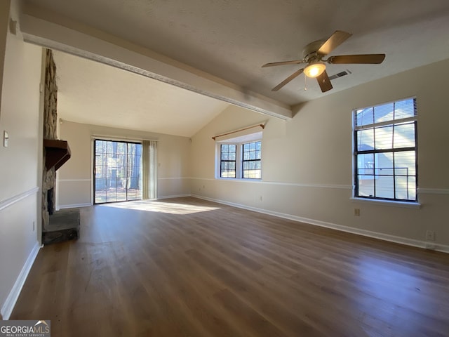 unfurnished living room featuring a healthy amount of sunlight, vaulted ceiling with beams, ceiling fan, and dark wood-type flooring