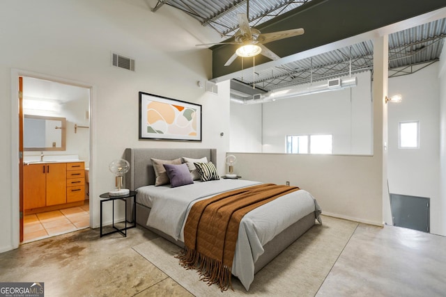 bedroom with concrete flooring, visible vents, and a high ceiling