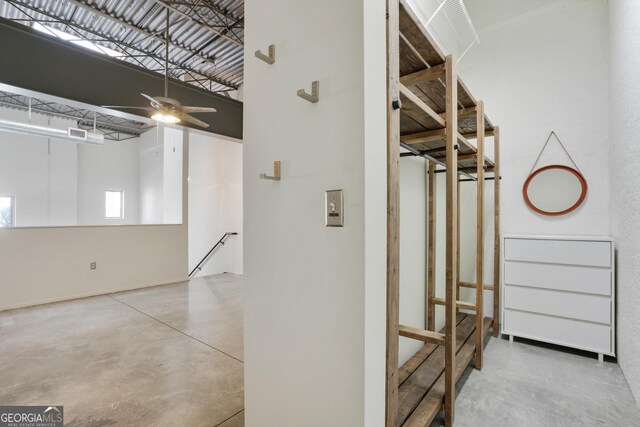 laundry room featuring stacked washer / dryer and electric panel