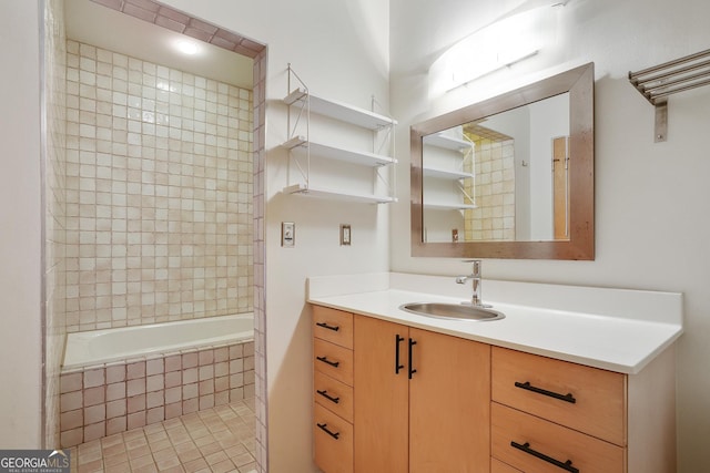 bathroom featuring tiled shower / bath combo and vanity