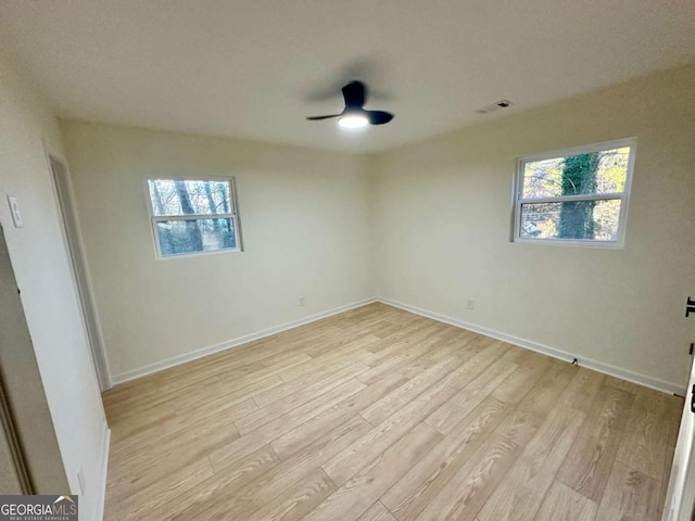 unfurnished room with ceiling fan, light hardwood / wood-style flooring, and a wealth of natural light