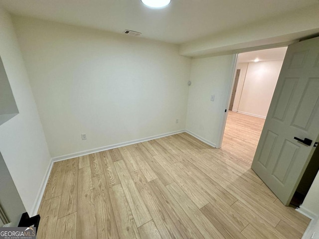 spare room featuring light hardwood / wood-style floors