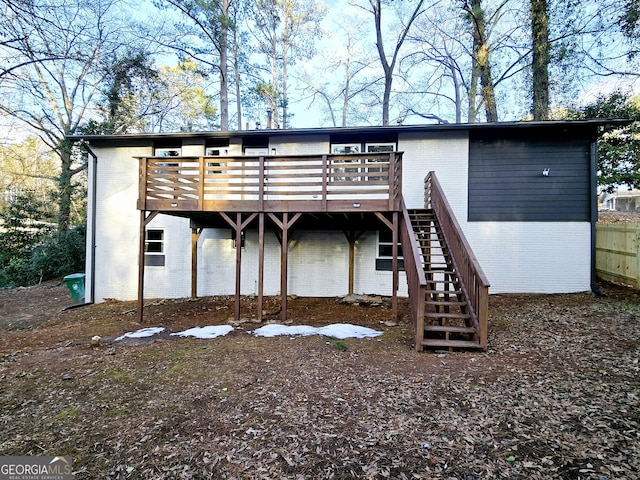 rear view of property with a wooden deck