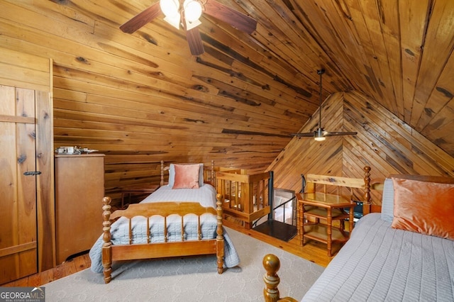 bedroom with vaulted ceiling, wooden walls, and wood ceiling