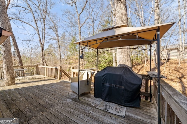 wooden terrace with a gazebo and grilling area