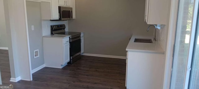 kitchen with dark hardwood / wood-style floors, white cabinetry, sink, and black electric range