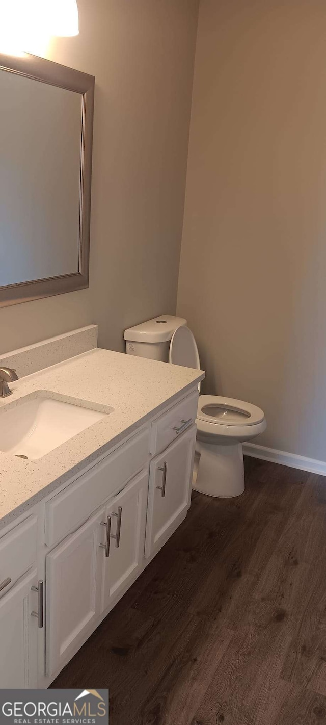 bathroom featuring hardwood / wood-style floors, vanity, and toilet