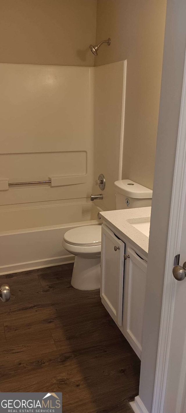 full bathroom featuring vanity, hardwood / wood-style flooring, toilet, and tub / shower combination