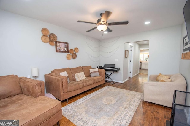 living room featuring dark hardwood / wood-style floors and ceiling fan