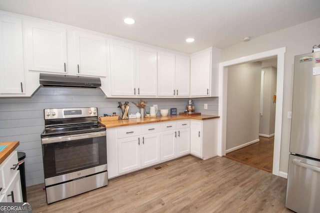 kitchen with white cabinets, light hardwood / wood-style floors, stainless steel appliances, and wooden counters