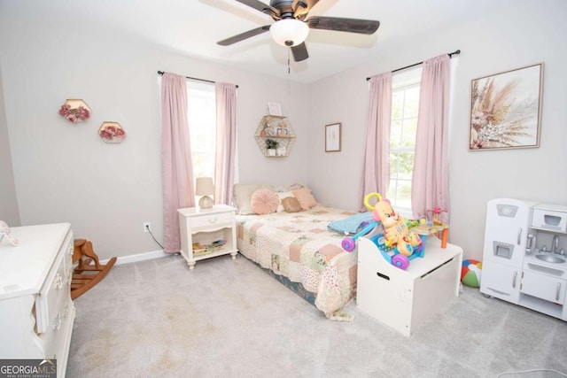 bedroom featuring ceiling fan and light carpet