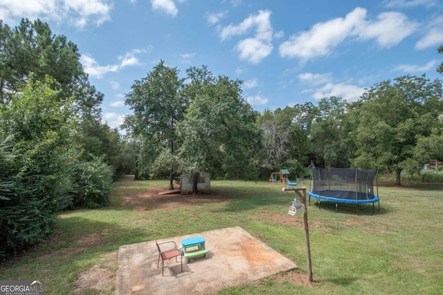 view of yard featuring a playground, a patio, and a trampoline