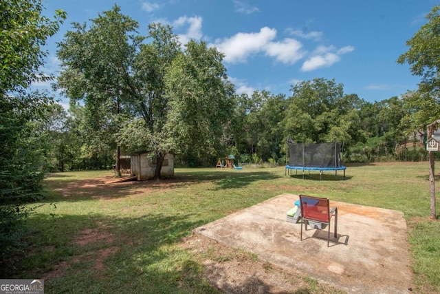 view of yard with a playground, a patio, and a trampoline