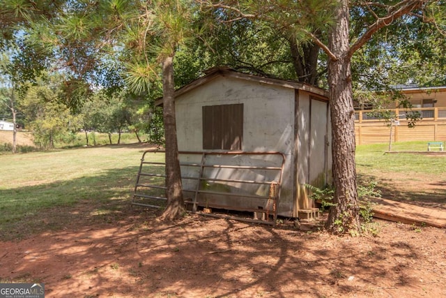 view of outdoor structure featuring a lawn