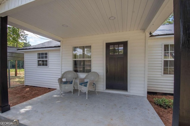 view of exterior entry featuring a patio