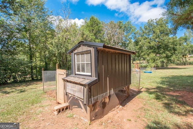 view of outbuilding featuring a lawn