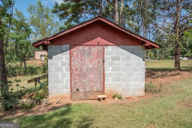 view of outbuilding with a lawn