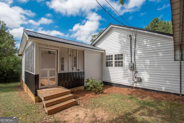 rear view of house featuring a sunroom