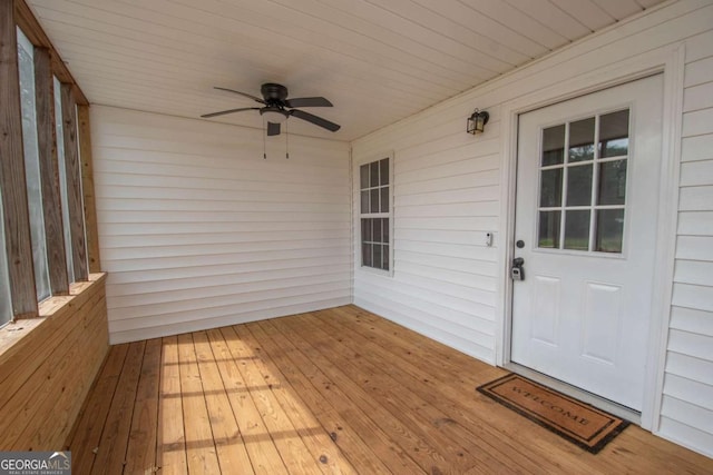 wooden deck featuring ceiling fan