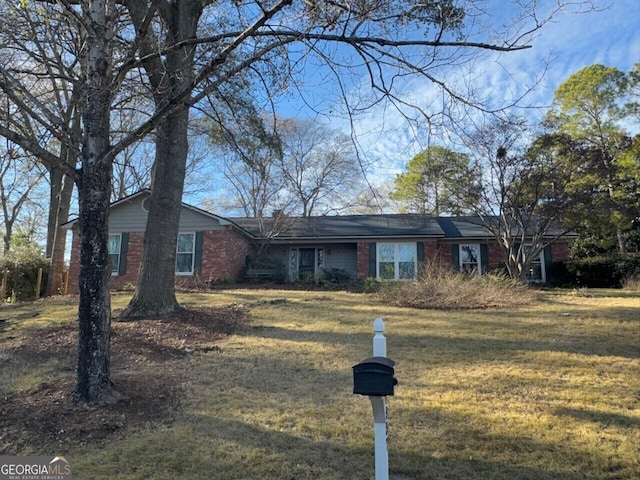 ranch-style home with a front lawn