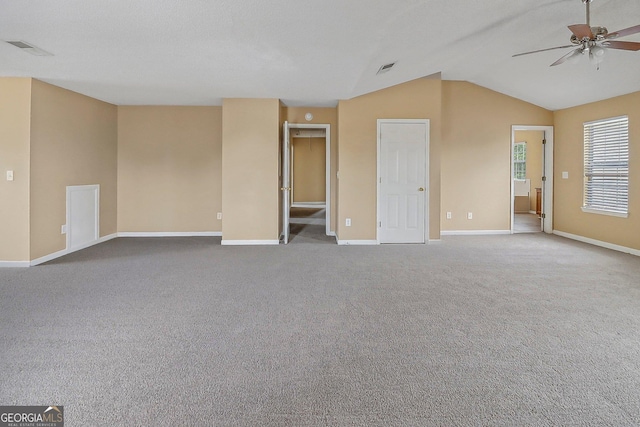 carpeted empty room with ceiling fan and lofted ceiling