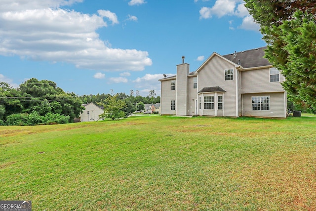 rear view of property featuring a yard