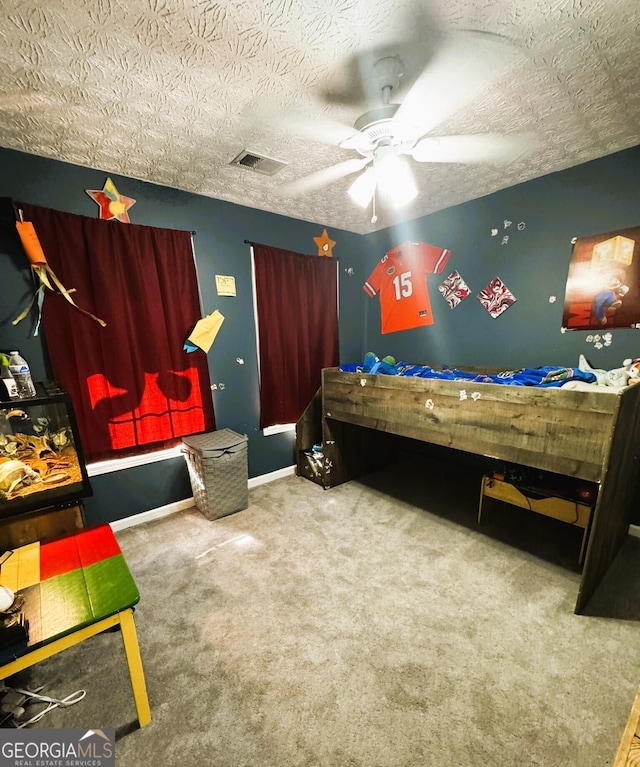 504 Plantation Creek Dr, Loganville, GA 30052 - carpeted bedroom with visible vents, ceiling fan, baseboards, and a textured ceiling