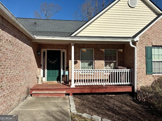 504 Plantation Creek Dr, Loganville, GA 30052 - view of exterior entry featuring brick siding, roof with shingles, and a porch