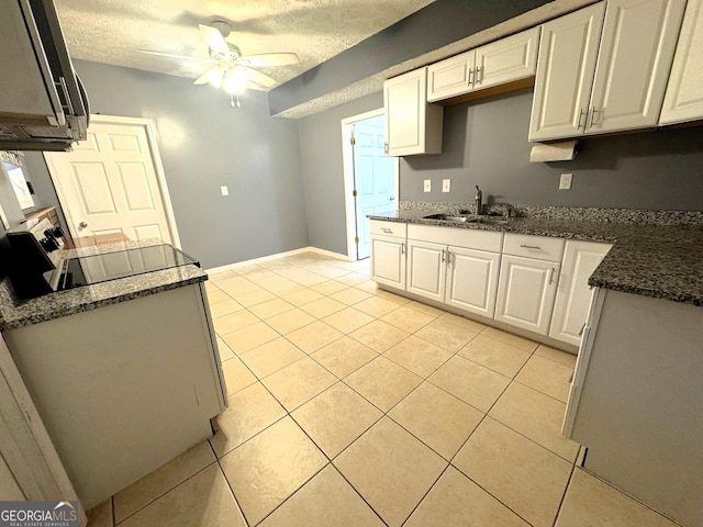504 Plantation Creek Dr, Loganville, GA 30052 - kitchen with white cabinets, a sink, and a ceiling fan