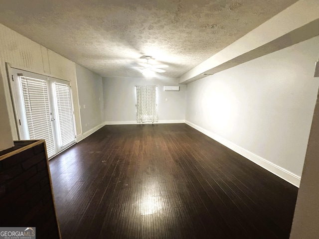 unfurnished room featuring ceiling fan, dark hardwood / wood-style flooring, and a textured ceiling