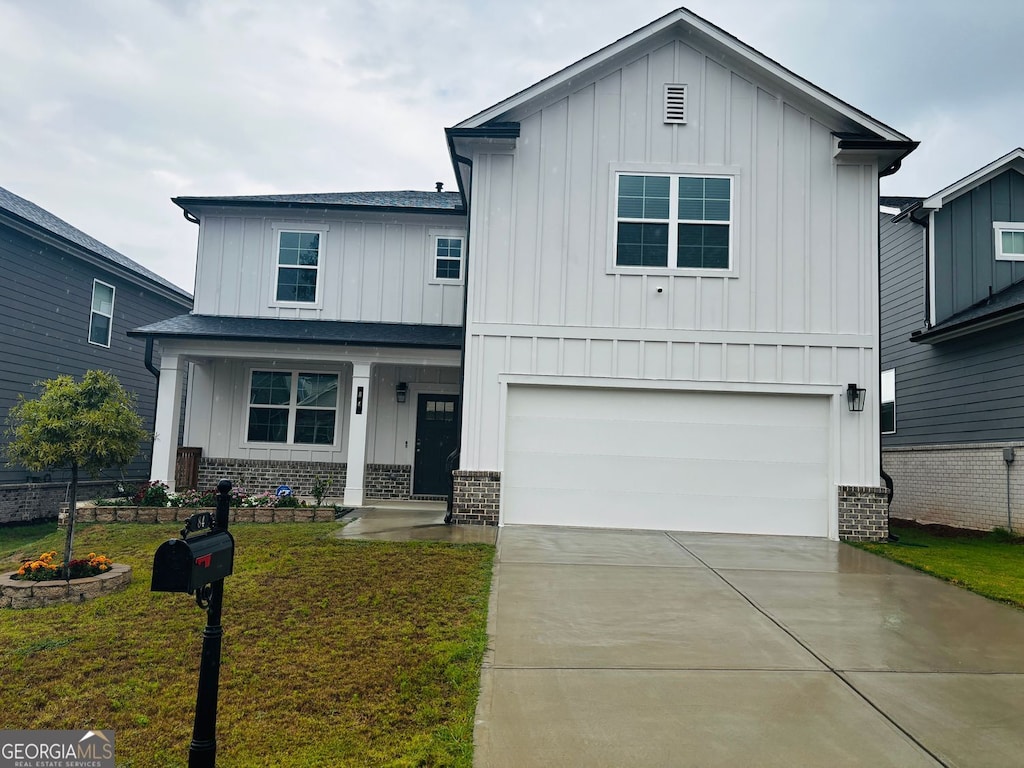 view of front of house with a front yard and a garage