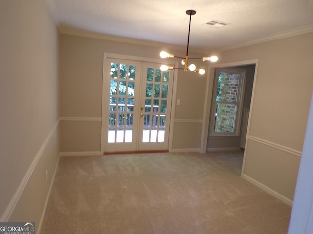 unfurnished dining area featuring french doors, carpet, and ornamental molding