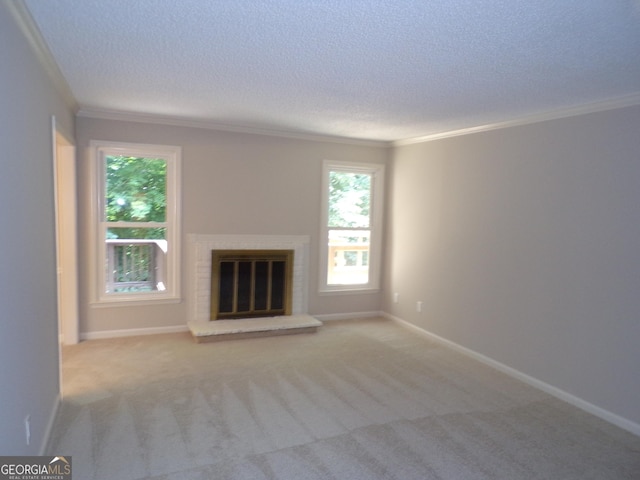 unfurnished living room featuring light colored carpet, ornamental molding, a textured ceiling, and a brick fireplace