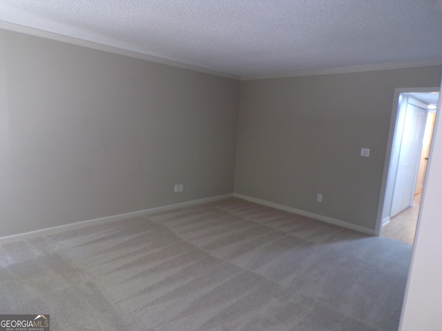 unfurnished room with light carpet, a textured ceiling, and ornamental molding