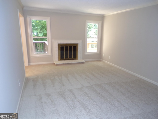 unfurnished living room with crown molding, light colored carpet, and a fireplace