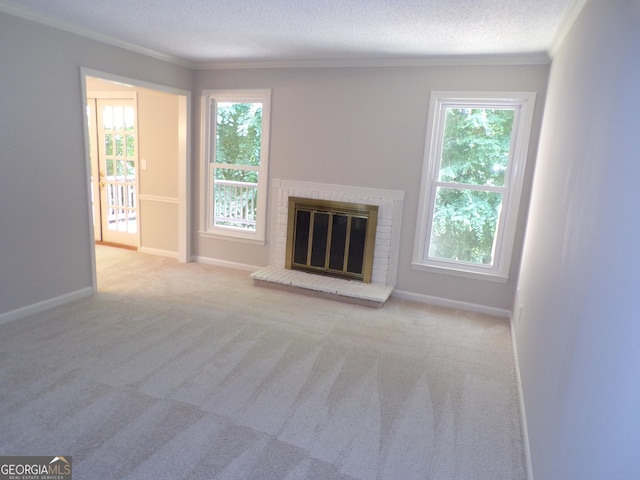 unfurnished living room featuring a textured ceiling, ornamental molding, light carpet, and a brick fireplace