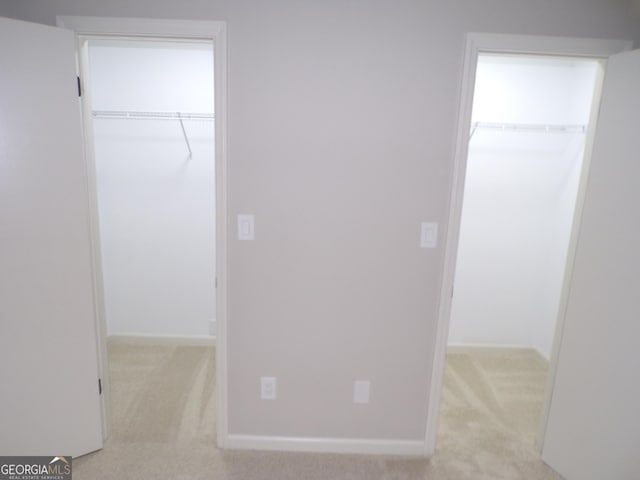 hallway with light colored carpet