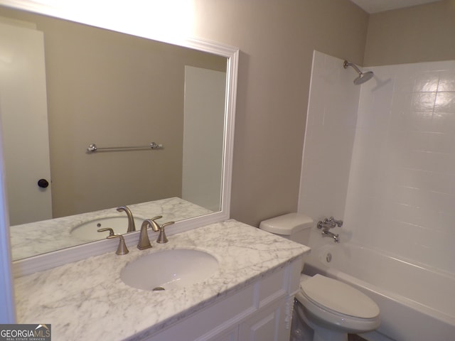 full bathroom featuring washtub / shower combination, vanity, and toilet