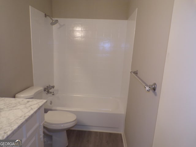 full bathroom with hardwood / wood-style floors, vanity, toilet, and shower / tub combination