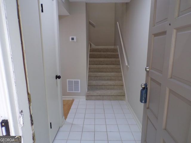 staircase with tile patterned floors