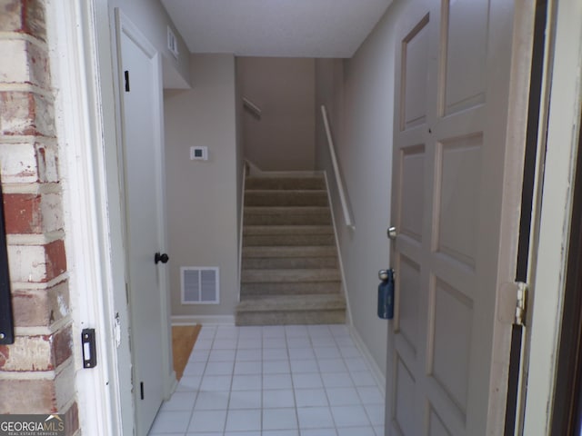 stairs featuring tile patterned flooring