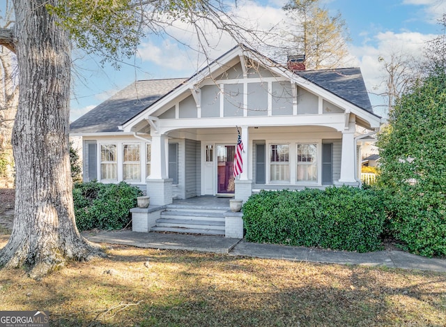 tudor-style house with covered porch