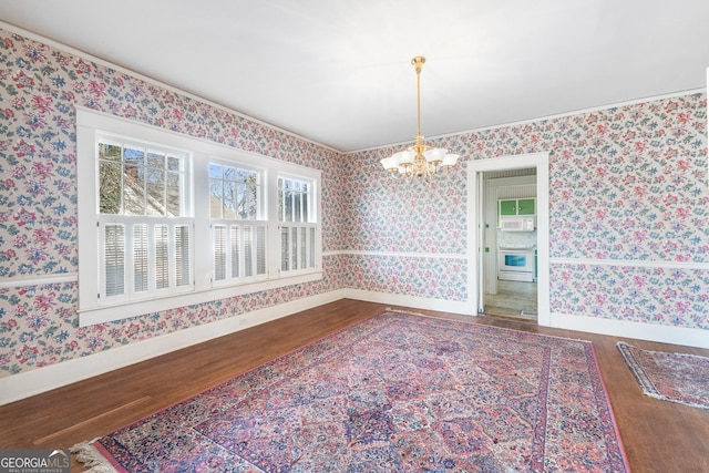 dining space featuring dark wood-type flooring, a chandelier, and ornamental molding