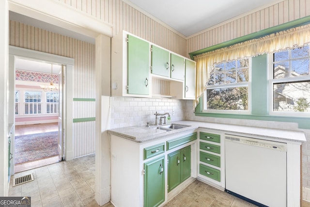 kitchen with a wealth of natural light, dishwasher, sink, and green cabinetry