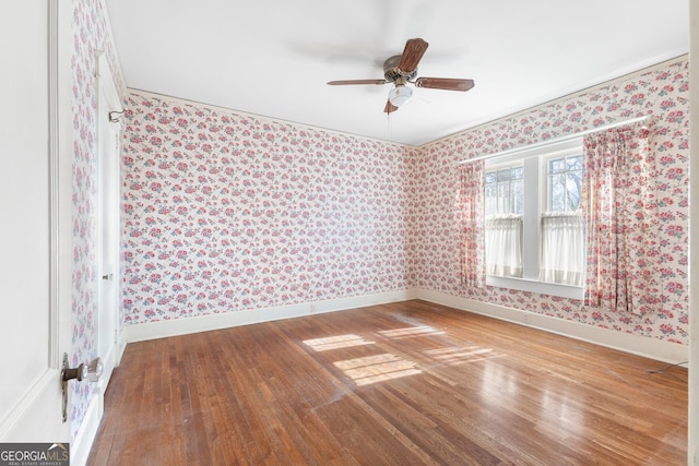 spare room with ceiling fan, hardwood / wood-style floors, and ornamental molding